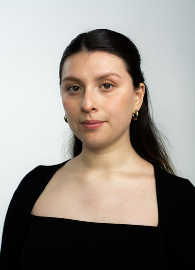A white woman with dark hair and a black blouse. Photo credit: Michelle Hipólito.