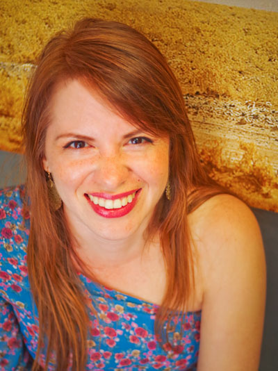 White Mexican Woman with reddish brown hair and a blue dress.