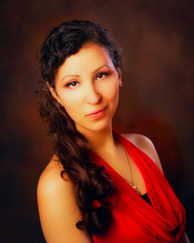 A person with brown hair wearing a red shirt. Photo credit: Cathy Broderick