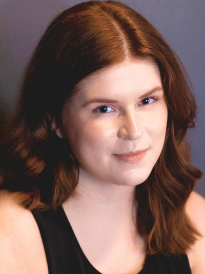 A white woman with long red hair.