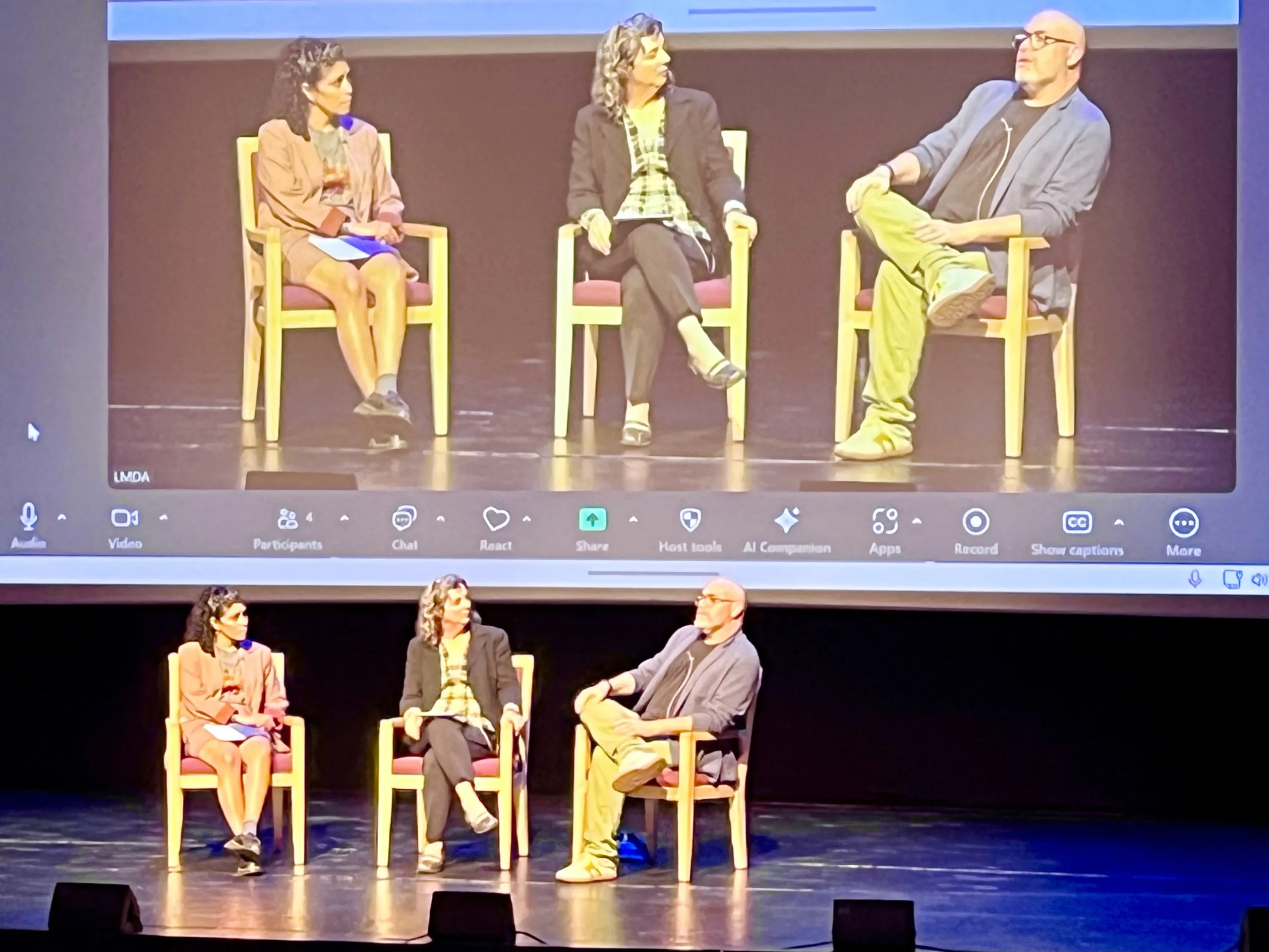Three speakers, Patrice Amon, Danielle Amato, and Jeremy Cohen, participate in a panel discussion on stage at a keynote event.